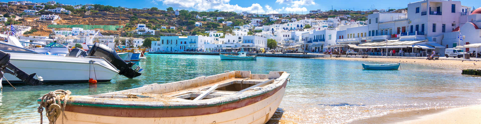 https://s1.travix.com/eu/europe-greece-mykonos-beach-boats-xlarge.jpg