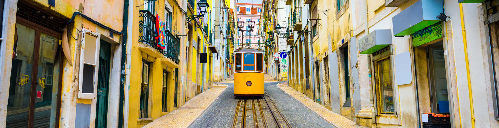 https://s1.travix.com/eu/europe-portugal-lisbon-tram-middle-old-houses-xlarge.jpg