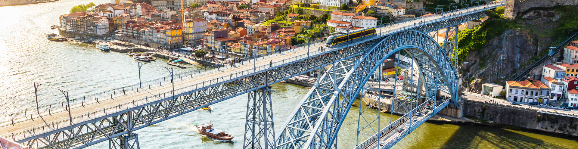 https://s1.travix.com/eu/europe-portugal-porto-luis-bridge-sun-xlarge.jpg